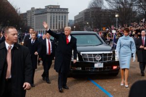 President Donald Trump waves as he walks with first lady Melania Trump during the inauguration parade in Washington, DC, on January 20, 2017 following swearing-in ceremonies on Capitol Hill earlier today. / AFP / POOL / Evan Vucci (Photo credit should read EVAN VUCCI/AFP/Getty Images)