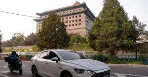 Електрическият автомобил (EV) Qin на BYD се движи по улица в Пекин